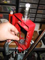 Place charged case in your reloading press